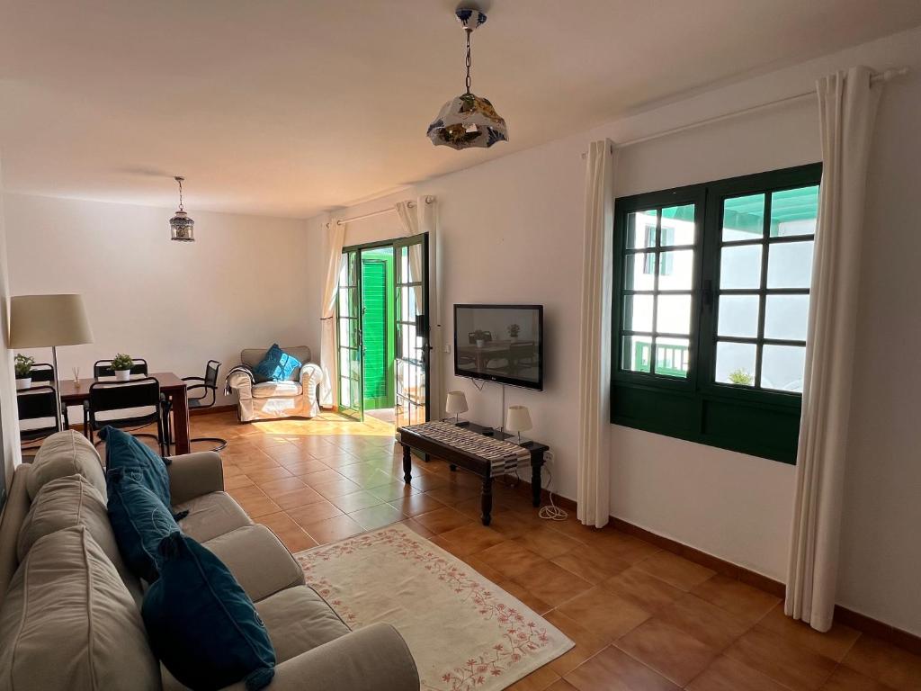 a living room with a couch and a table at Apartment Sonrisa - spacious two bedroom apartment in Costa Teguise