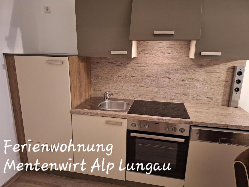 a kitchen with a sink and a stove at Ferienwohnung Mentenwirt Alp Lungau in Sankt Michael im Lungau