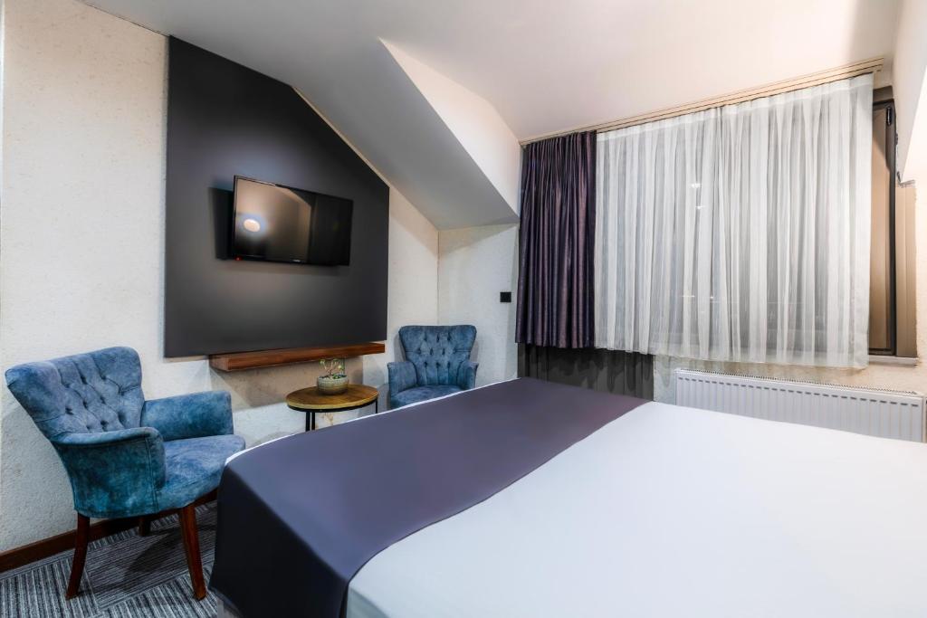 Postel nebo postele na pokoji v ubytování MED Airport Hotel