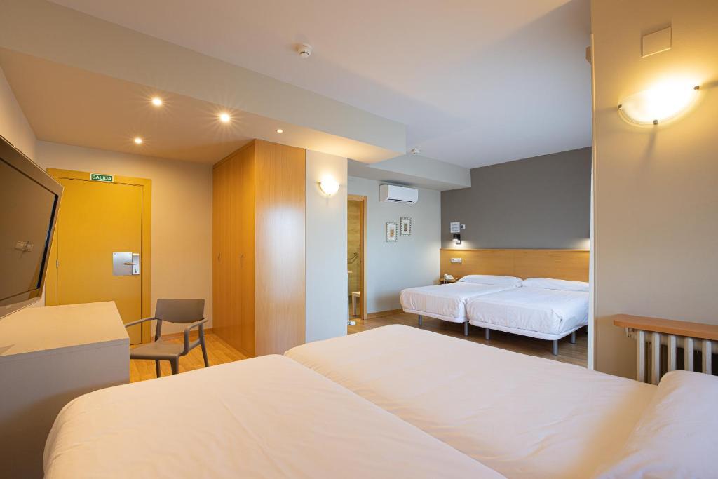 Postel nebo postele na pokoji v ubytování Hotel Santamaria