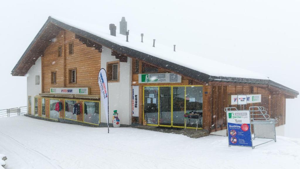 a building in the snow with a store at Christiania in Riederalp