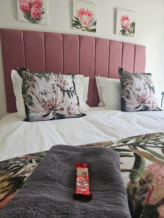 a bed with two pillows and a blanket on it at Protea Guesthouse in Middelburg