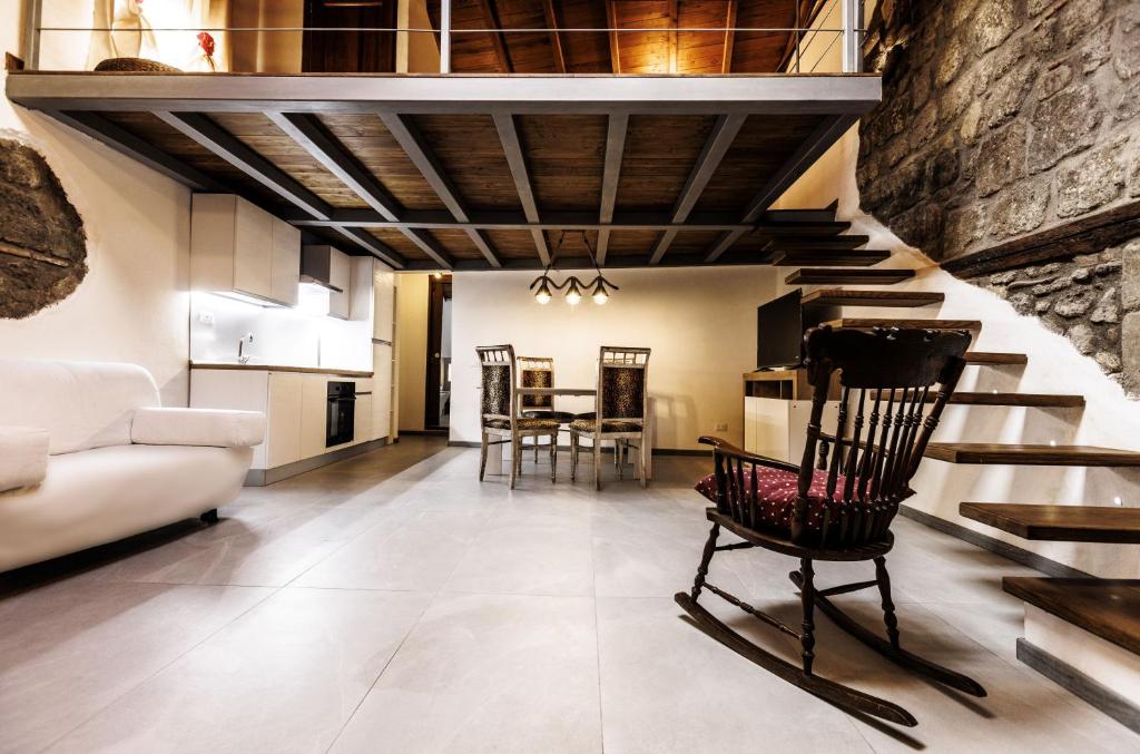 a living room with a staircase and a chair at La Soffitta della nonna in Ronciglione