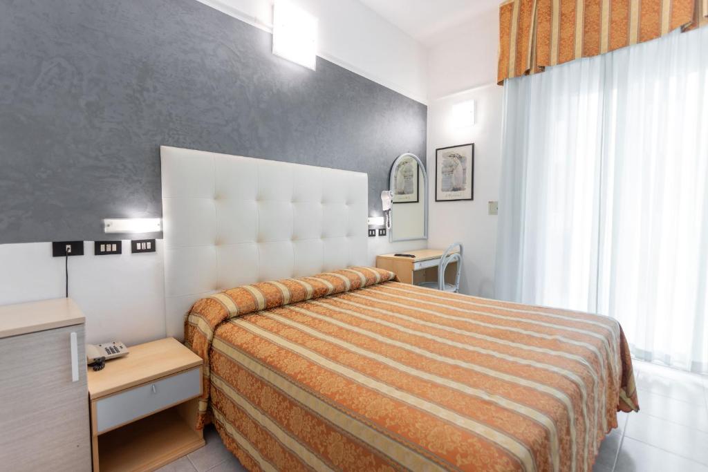 Postel nebo postele na pokoji v ubytování Hotel Nettuno