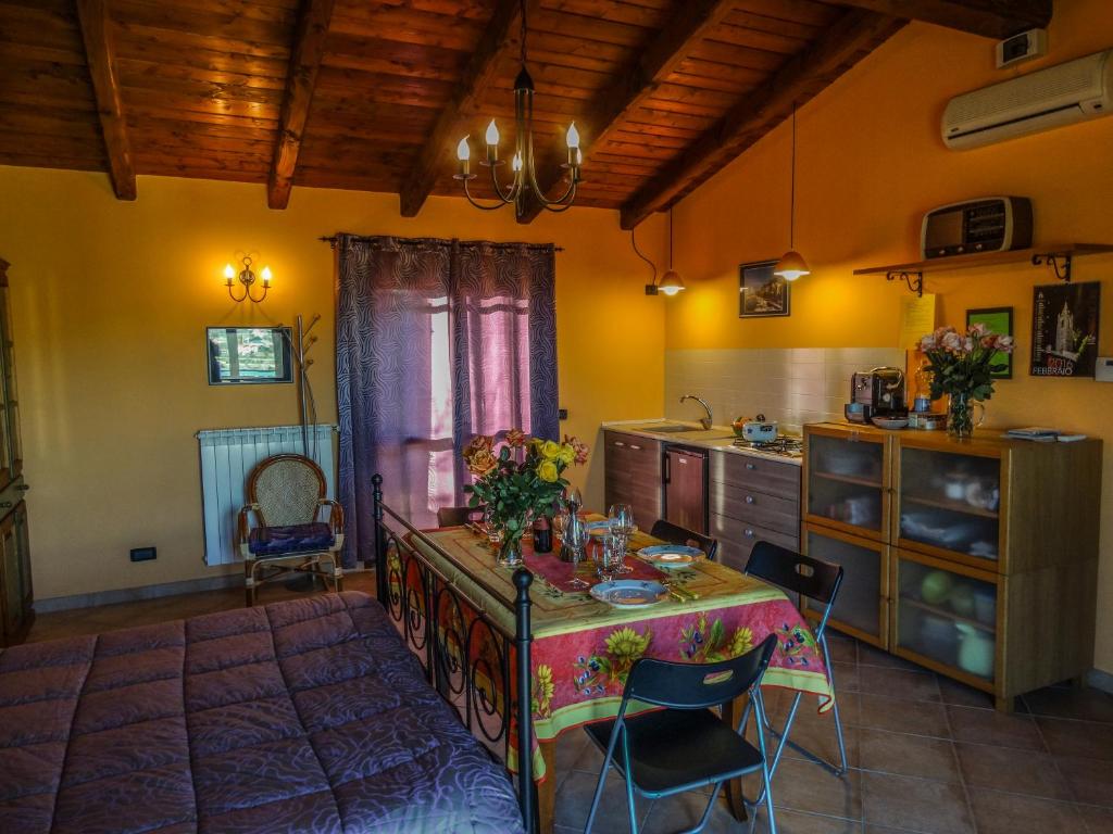 a kitchen with a table and chairs in a room at Strada Casai 19 in Riva Ligure