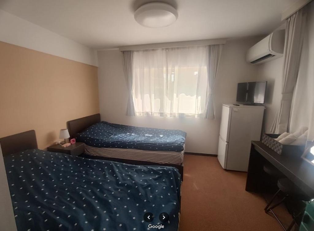 Postel nebo postele na pokoji v ubytování Hotel Yuni Star-Club