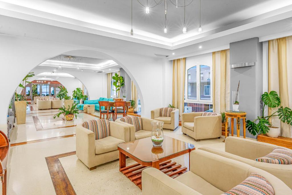 a living room with couches and a table at Glaros Beach Hotel in Hersonissos