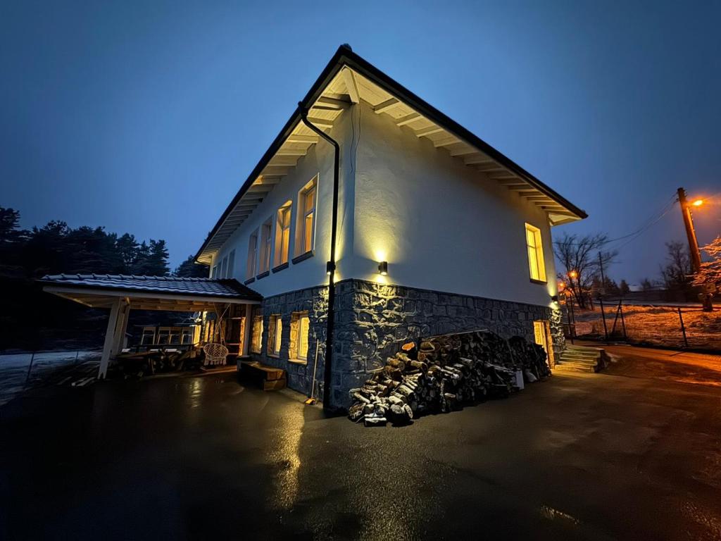 a building with a fire pit in front of it at Villa The Old School Plana with Hot Pool & SPA by BookVillaBG in Plana