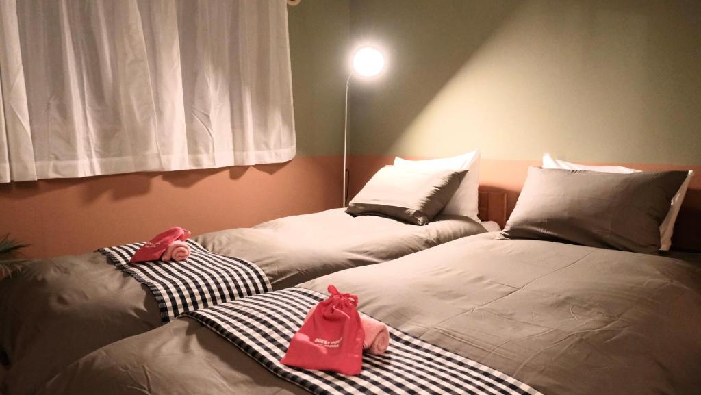 Guesthouse HOALOHA 4 SEASONSにあるベッド