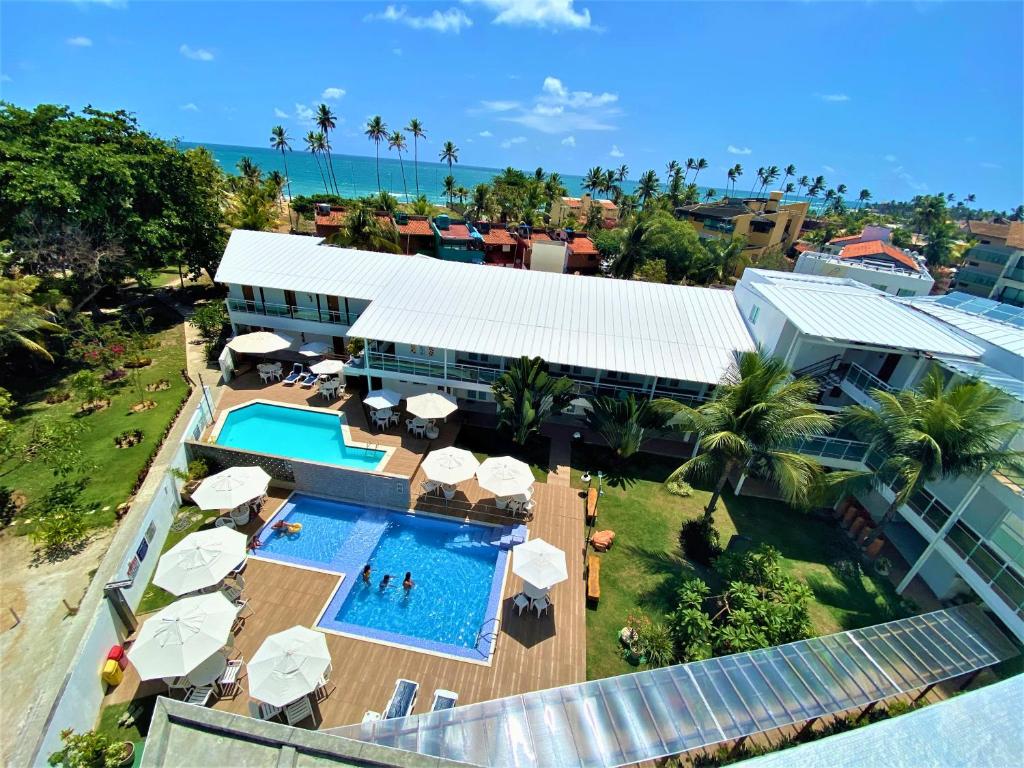 an aerial view of a resort with a swimming pool at Hotel Vivenda dos Corais in Porto De Galinhas
