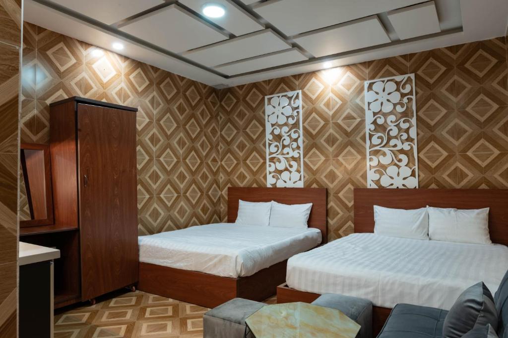 Postel nebo postele na pokoji v ubytování LÉ BOISE HOTEL Đà Lạt
