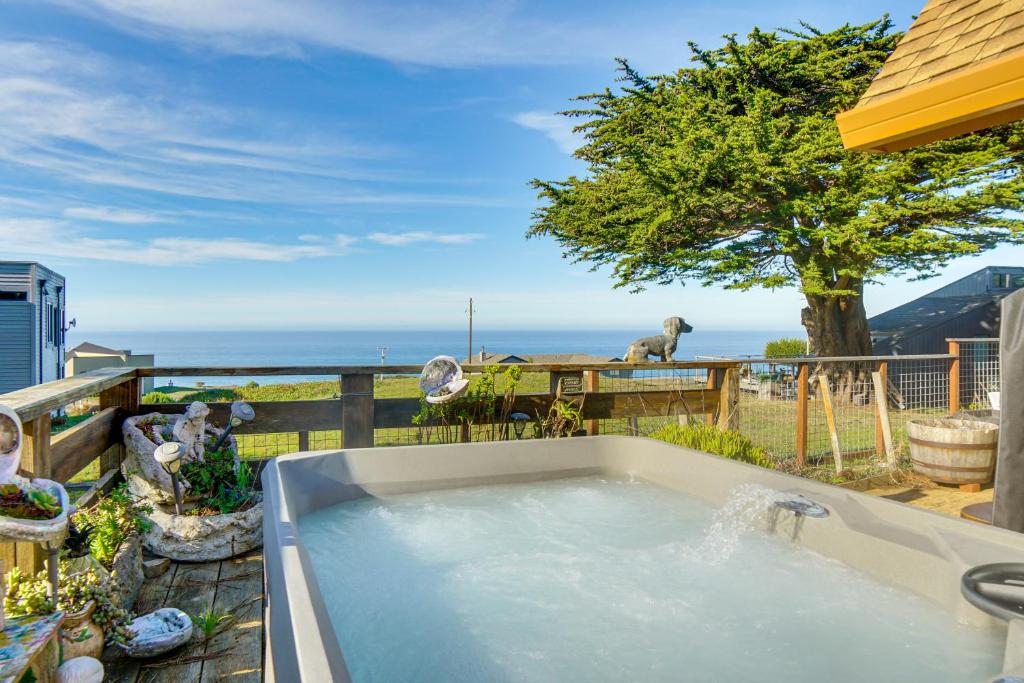 a hot tub on a balcony with a view of the ocean at Private Beach Access Pet-Friendly California Gem! in Manchester