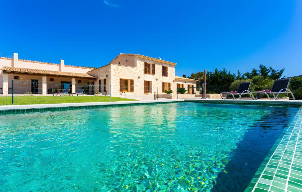 a swimming pool in front of a house at Pula Bonavista Ref 140 in Costa des Pins