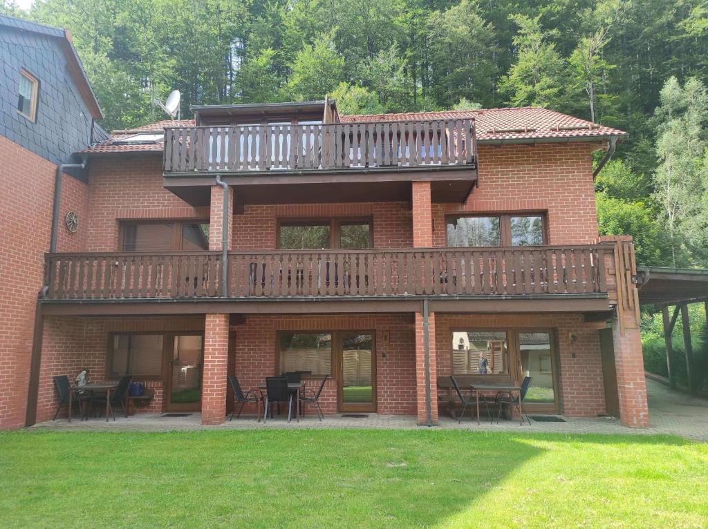 Una gran casa de ladrillo con una terraza. en Gästehaus Harzklause 1, en Sieber