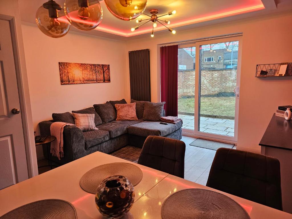 a living room with a couch and a table at Jasmin's House, 2 bedroom, Private Parking in Northampton
