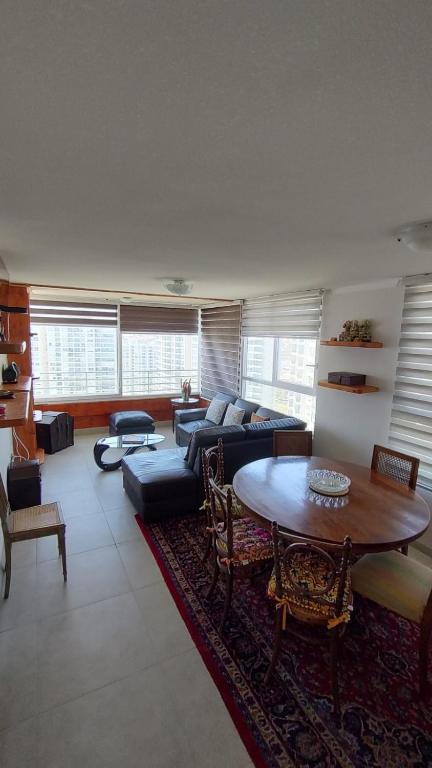 a living room with a couch and a table at Marina 1 piso 23 in Coquimbo