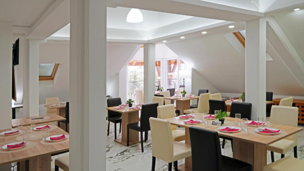 a dining room with wooden tables and chairs at Apartments Bramar in Zlatibor