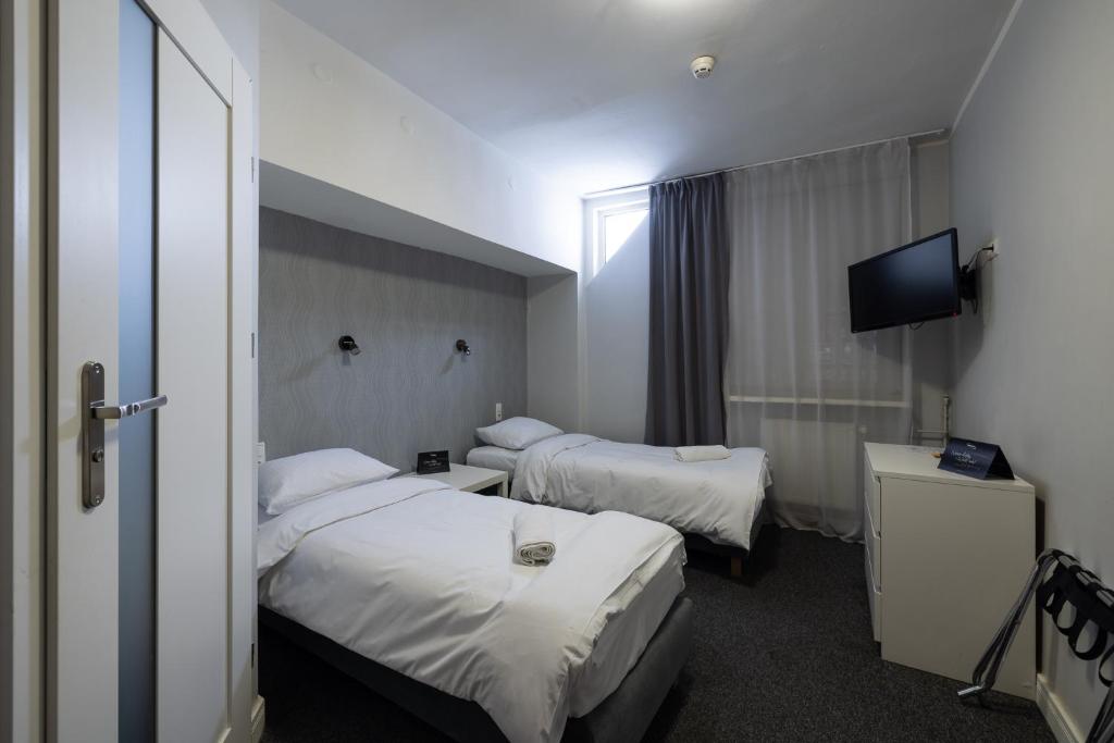 Postel nebo postele na pokoji v ubytování Hotel Orbita