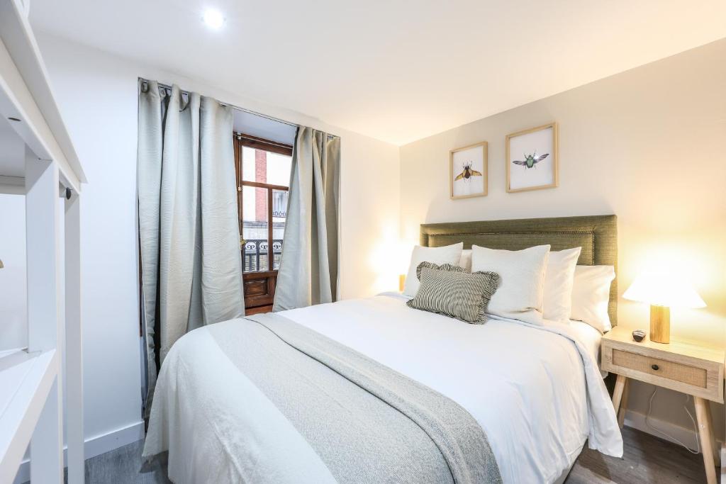 a bedroom with a white bed and a window at Password to Madrid Gran Vía in Madrid