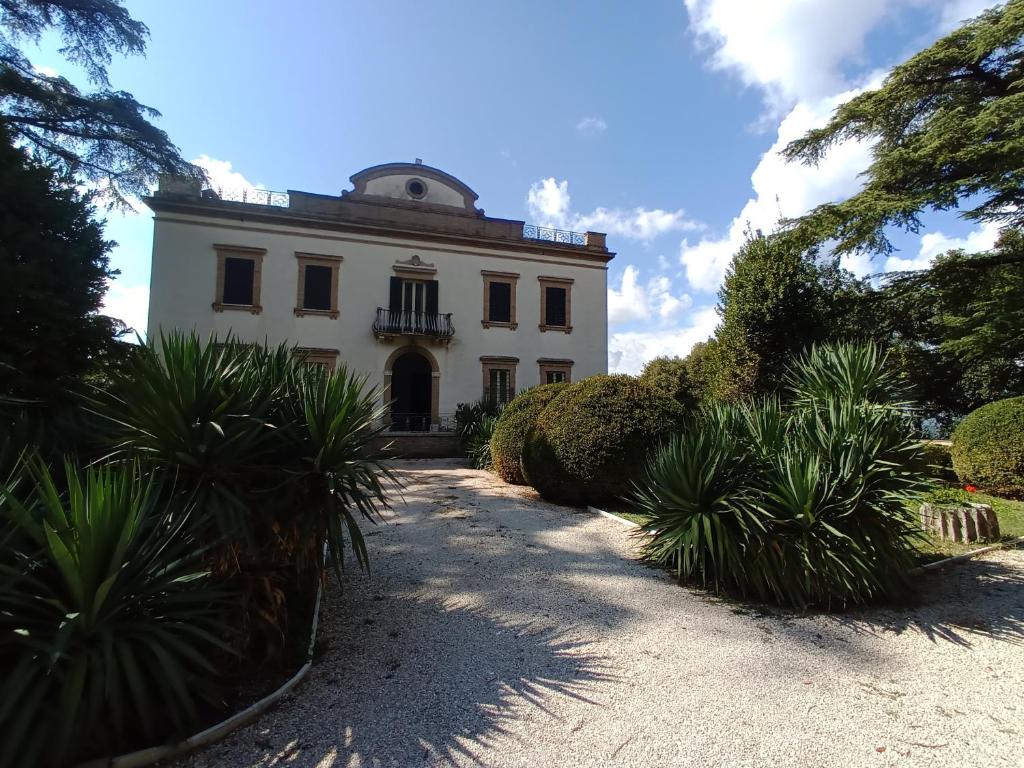 a white building with a dome on top of it at Villa Donna Anna in Assisi