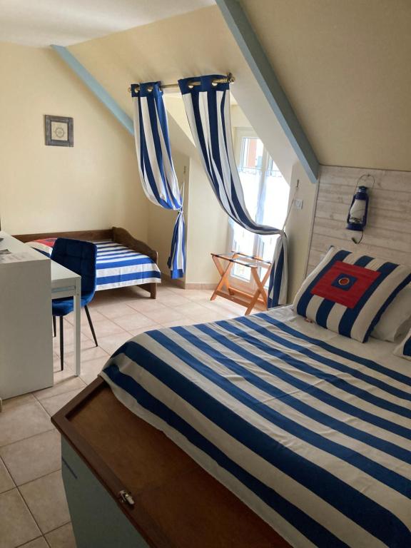 Postel nebo postele na pokoji v ubytování La Grande Mare