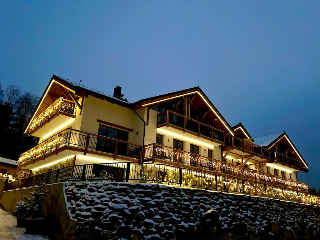 a large building with lights on it at night at Rezidence KUPEC in Frymburk