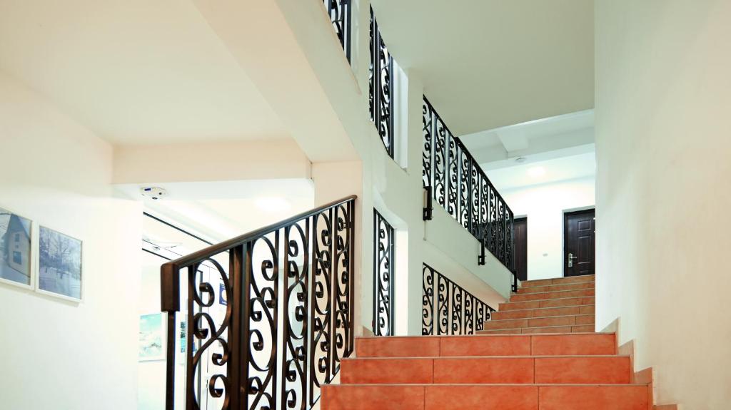 a set of stairs in a building with black railings at Apartments Bramar in Zlatibor