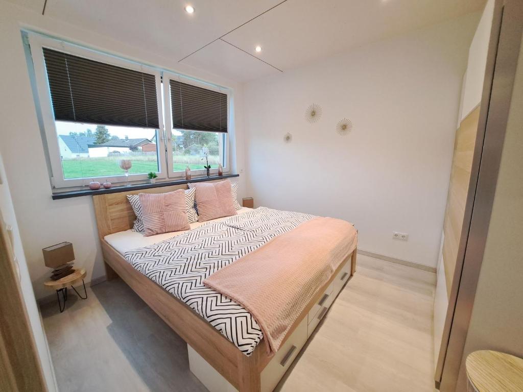 Postel nebo postele na pokoji v ubytování Ferienhaus - Fimo Haus