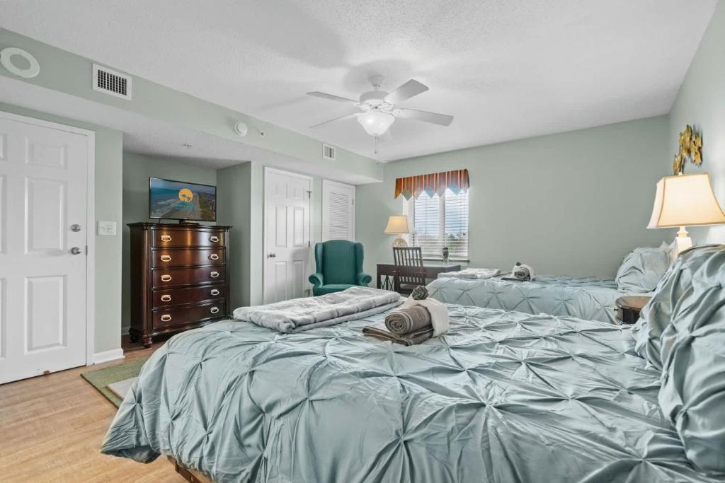 a bedroom with two beds and a ceiling fan at Yacht Club Villas 1-505 - Marina View in Myrtle Beach