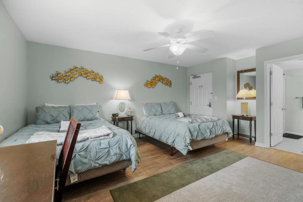 a bedroom with two beds and a ceiling fan at Yacht Club Villas 1-505 - Marina View in Myrtle Beach