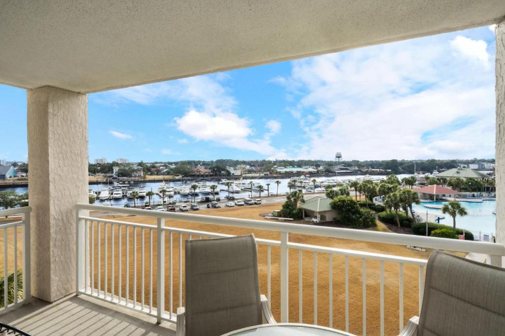 a balcony with chairs and a view of a marina at Yacht Club Villas 1-505 - Marina View in Myrtle Beach