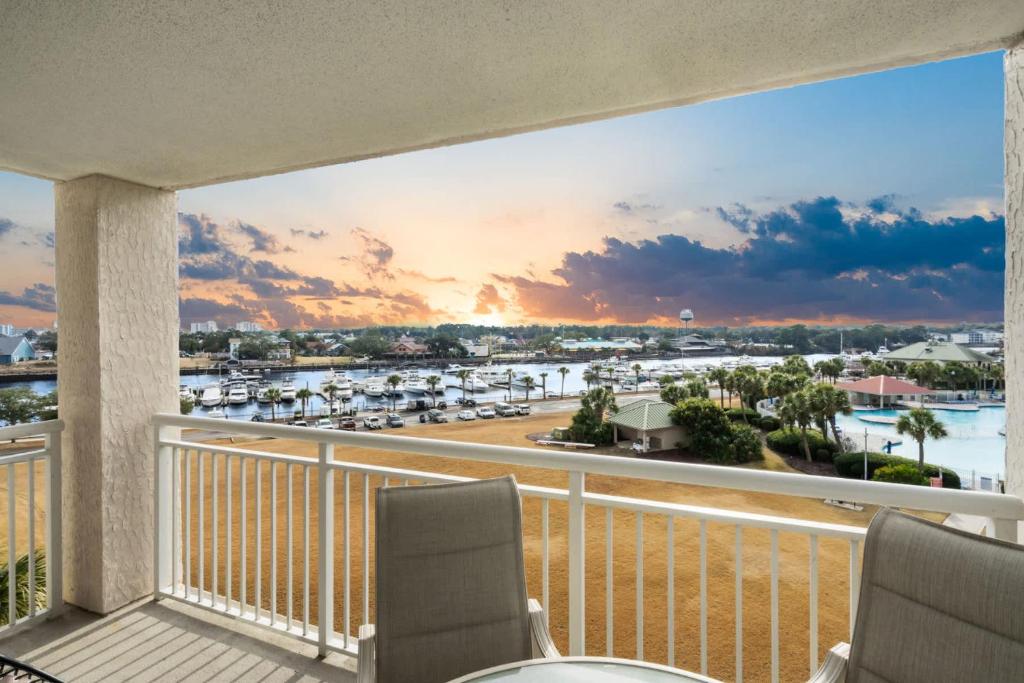 a balcony with chairs and a view of a marina at Yacht Club Villas 1-505 - Marina View in Myrtle Beach