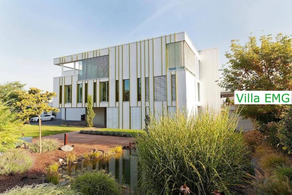 a rendering of a building with a pond in front of it at Luxury Villa EMG Frankfurt Heidelberg - Bensheim in Bensheim