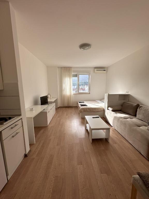 a living room with a couch and a table at Studio Apartment L in Mostar