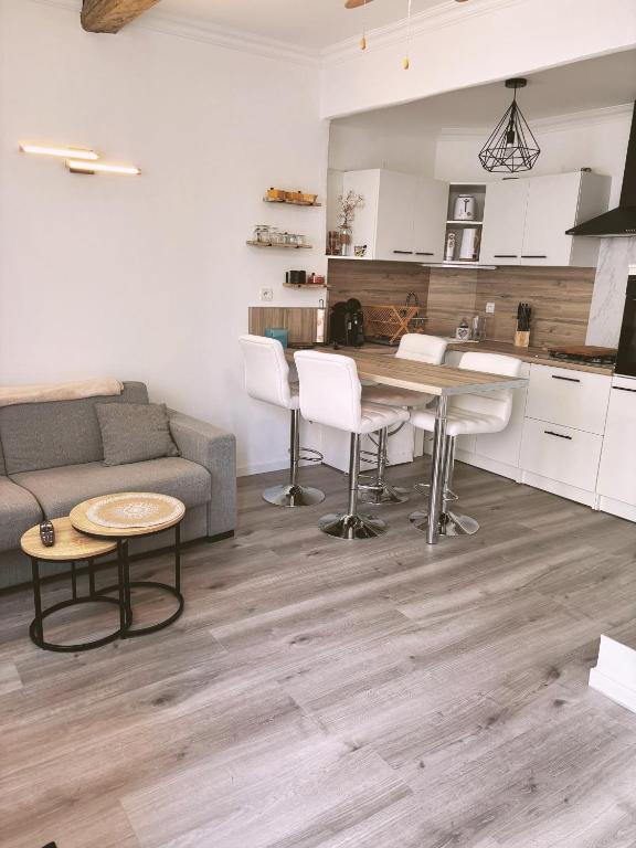 un salon avec un canapé et une table dans l'établissement Maison au cœur du village - Cocon de Provence, à Puget-sur Argens