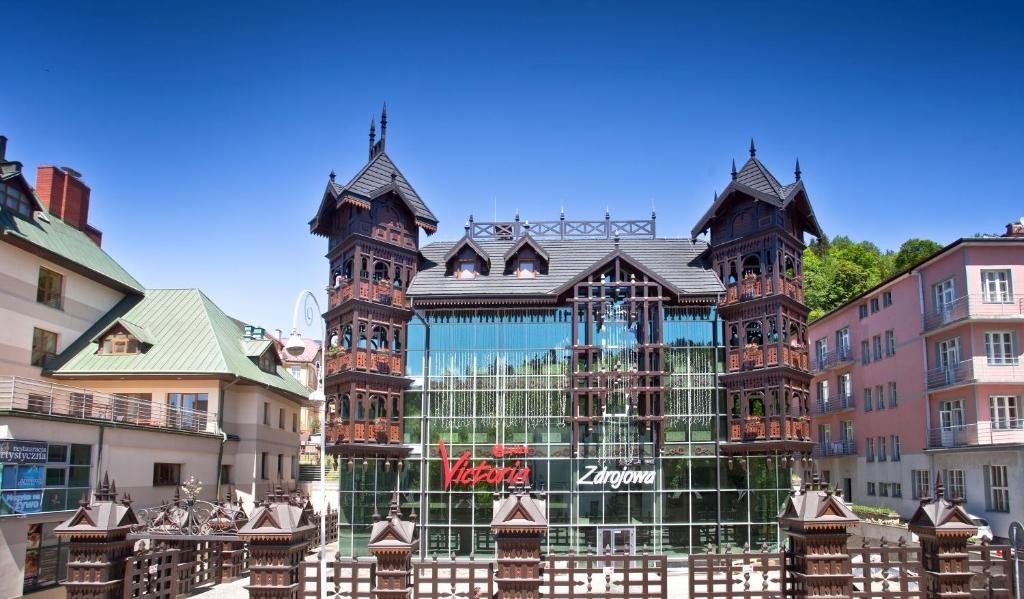 a large building in the middle of a city at Victoria Cechini in Krynica Zdrój