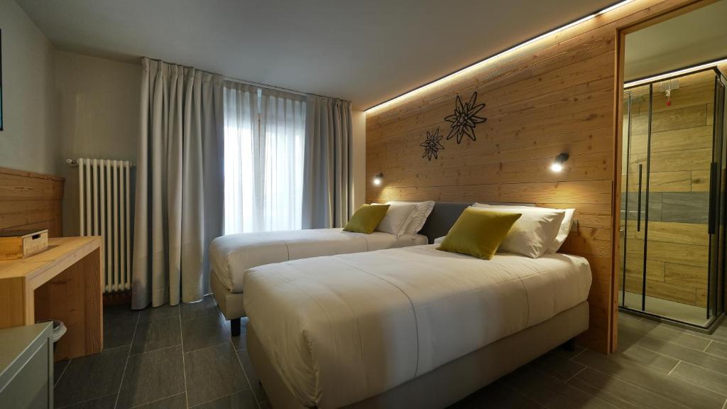 Postel nebo postele na pokoji v ubytování Hotel Perruquet