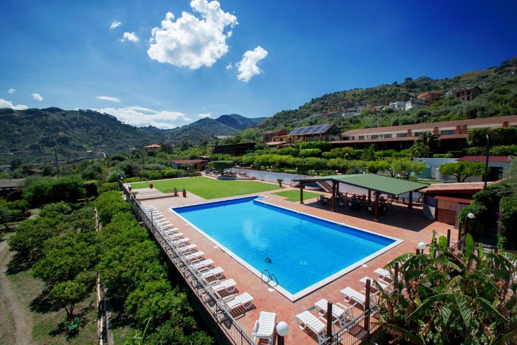 an overhead view of a swimming pool with lounge chairs at 'A Nuciara Park Hotel & Spa in Furci Siculo