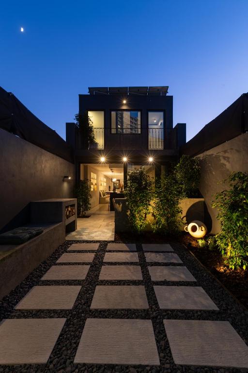 a house with a pathway in front of it at night at Santiago Beach House in Leça da Palmeira