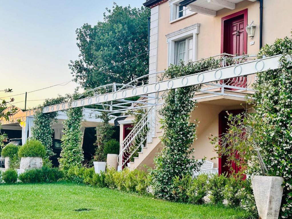 a house with a spiral staircase in a yard at Ca' del Conte - Maison de Charme in Padula