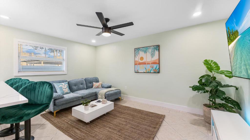 a living room with a couch and a ceiling fan at The Shark Tank Cocoa Beach - 2 2BR Units - 4BR Total - Each Unit Sleeps 5 - Walk to Downtown & Beach in Cocoa Beach