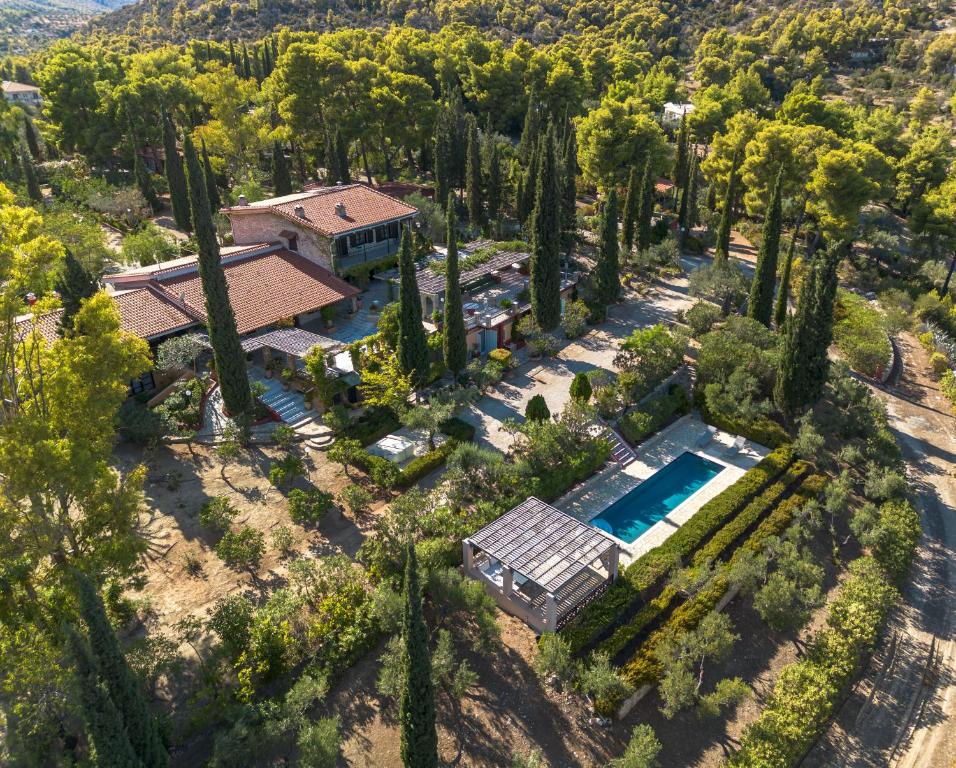 an aerial view of a house with a pool and trees at Corinthian Blue Retreat in Katakoúli