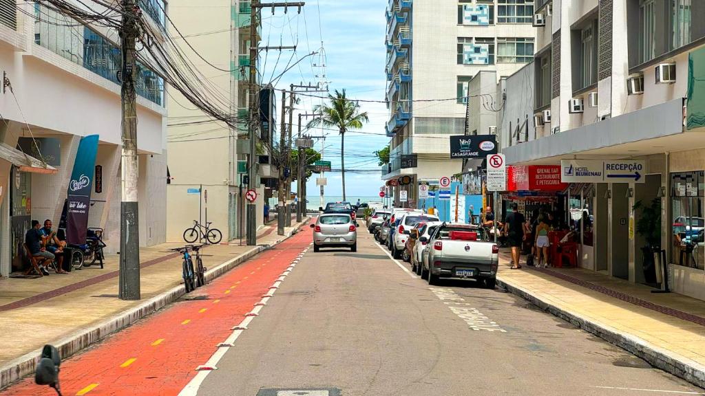 a city street with cars parked on the side of the road at 200 metros da Praia Central na Avenida Brasil próximo à Roda Gigante e Shopping Atlântico in Balneário Camboriú