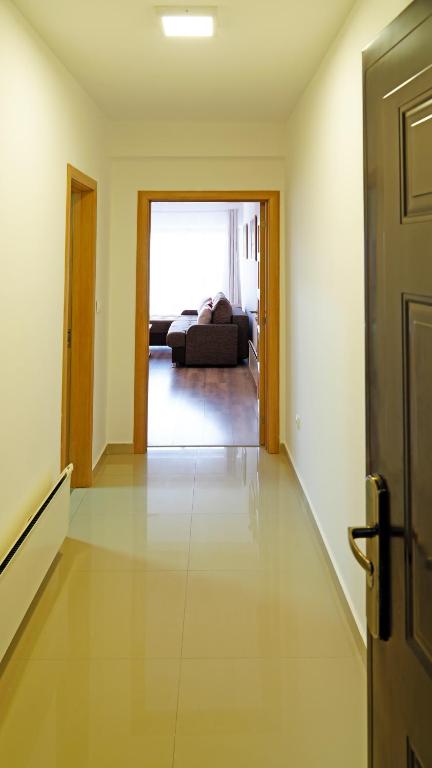 a hallway with a room with a bed and a door at Apartments Bramar in Zlatibor