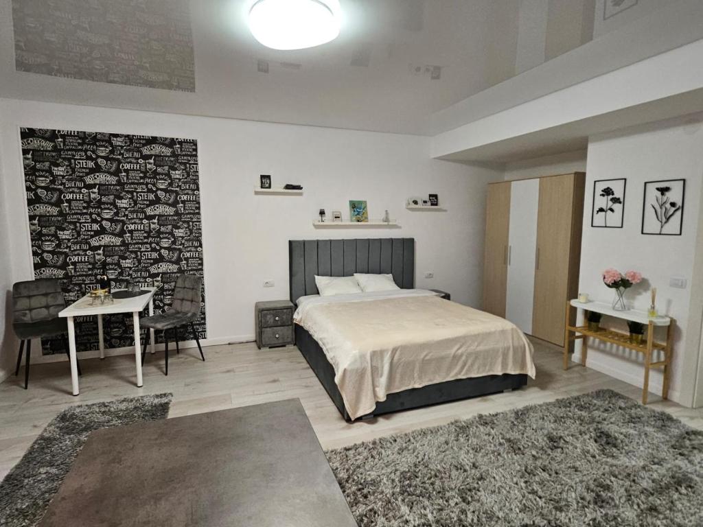a bedroom with a bed and two tables with rugs at DoubleC in Galaţi