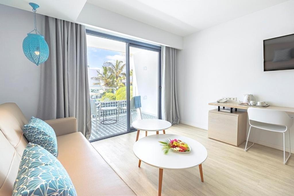 a living room with a couch and a table at Oasis Lanz Beach Mate in Costa Teguise