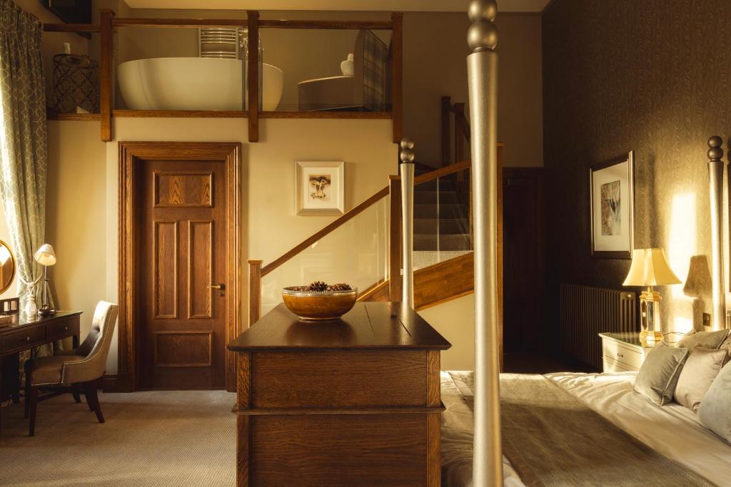 a bedroom with a bed and a bowl on a table at The Station Hotel in Rothes