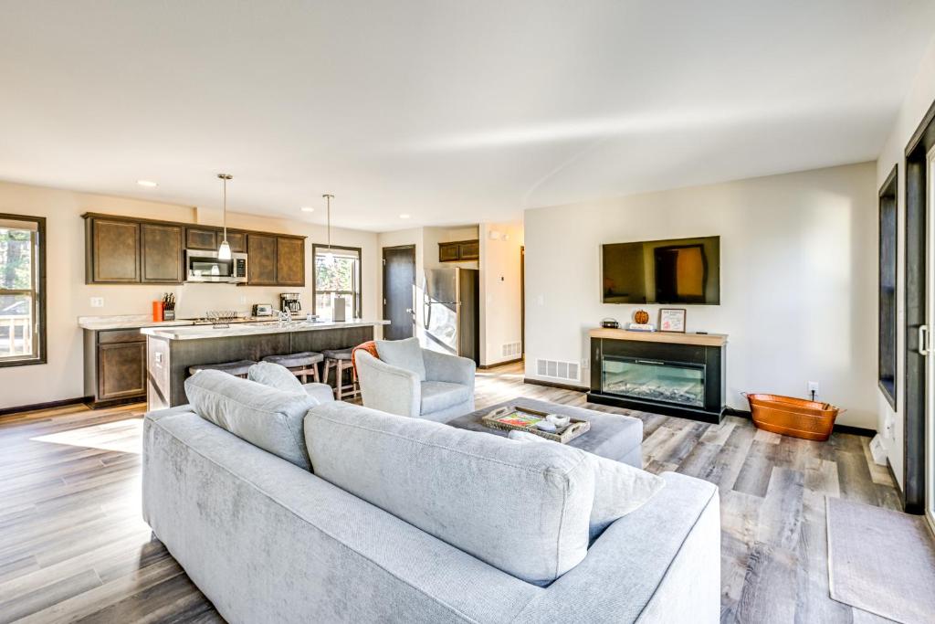 a living room with two couches and a fireplace at Golf, Hike and Boat Home with Fire Pit in Friendship in Friendship