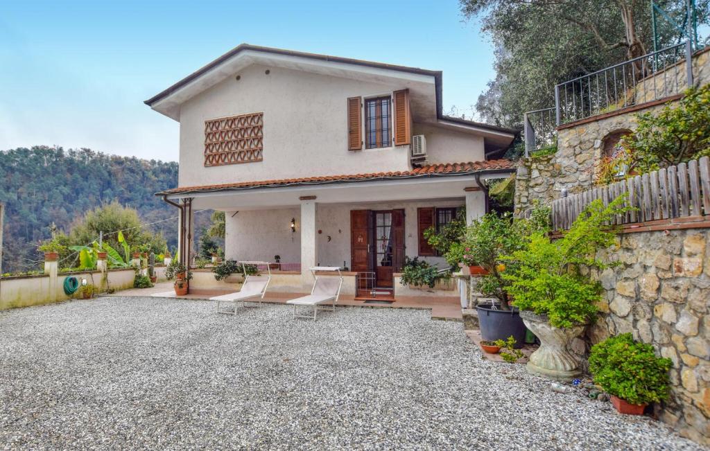 a house with a stone wall and a driveway at 3 Bedroom Gorgeous Home In Camaiore in Camaiore