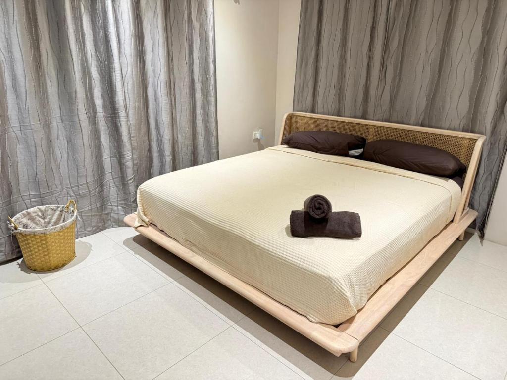 a bed with a brown object on top of it at Bula Bliss Nadi - 2 Bedroom Apartment with Mountain View in Nadi